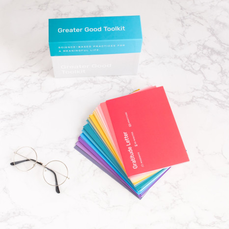 Toolkit box, practice cards and glasses sit on a marble surface